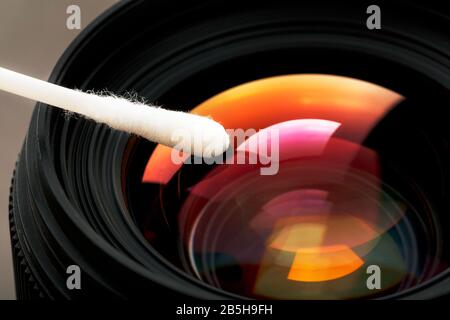 Gentle cleaning with a cotton swab camera Lens with a beautiful optical block close-up. Macro In full screen Stock Photo