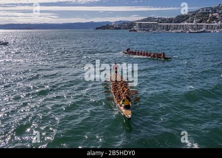 Two dragon boats just after passing finishing line Stock Photo