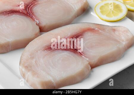 Two raw fresh swordfish fillets on a dish close up Stock Photo