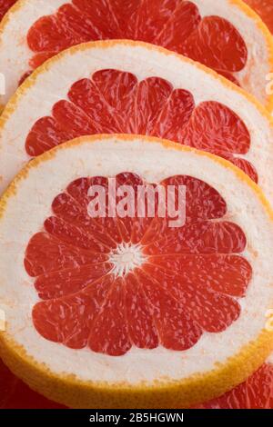 Slices of fresh ripe juicy red grapefruit close up Stock Photo