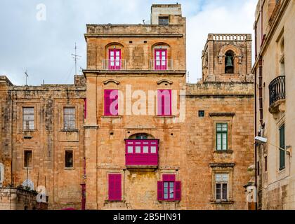 Old houses with colorful wooden balconies in La Valletta, Malta, typical of the traditional Maltese architecture. Stock Photo