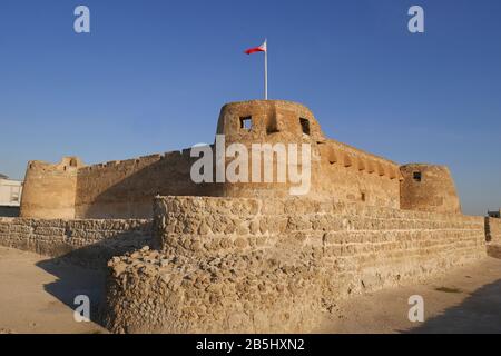 Arad Fort with the Bahrain flag flying, Muharraq, Kingdom of Bahrain Stock Photo