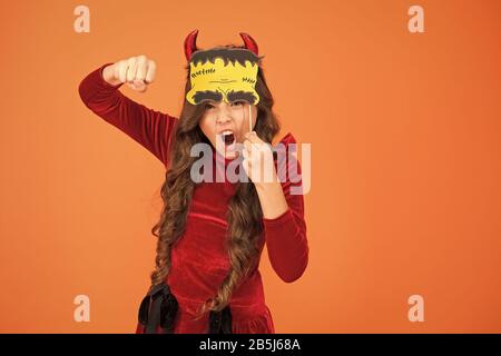 Trick or treat concept. Small child imp style accessory. Halloween party. Halloween costumes. Photo booth props. Autumn holiday. Little girl cute small horns celebrate Halloween. Carnival concept. Stock Photo