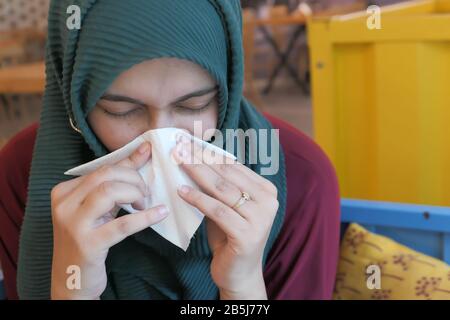 Closeup on ill elegant woman wiping nose with napkin Stock Photo