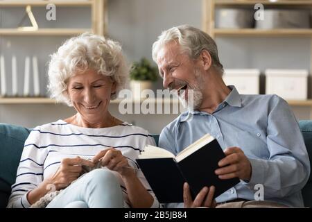 Happy mature couple engaged in favorite hobbies on home weekend Stock Photo