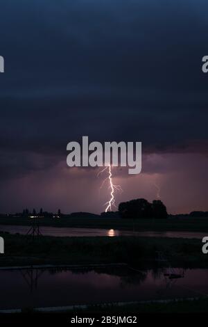 Stunning landscape image of lightning bolt in the sky over a river in ...