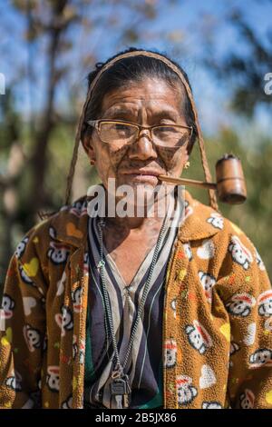 Local woman with tattooed face from village Mindat, Chin state, Myanmar, Asia. Stock Photo