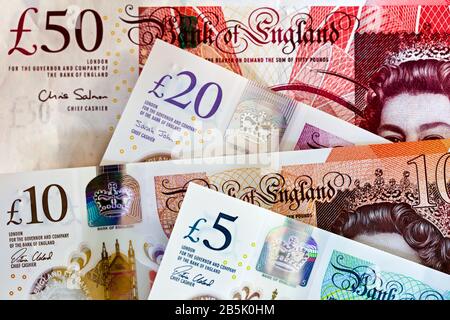 Bank of England £5, £10 and £20 polymer banknotes and the old £50 paper banknote Stock Photo