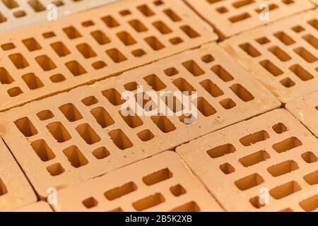 Building material red brick with holes. Close up. Stock Photo