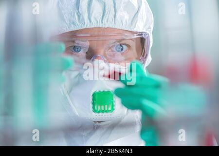 Virologist healthcare professional analyzing blood test sample in lab tubes, close up of medical worker working, selective focus Stock Photo