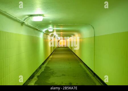 Underground pedestrian tunnel with green walls. Close up. Stock Photo