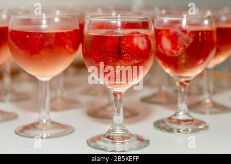 Beautifully decorated welcome drink - a glass of Prosecco or champagne with raspberry inside, served as a welcome drink on a event, party, wedding, re Stock Photo