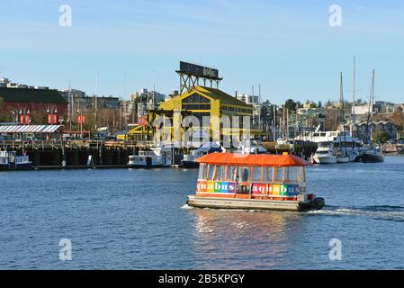 Vancouver, Canada - March 4, 2020:  Woman drives Aquabus False Creek Ferry that takes passengers from downtown Vancouver to Granville Island. Stock Photo