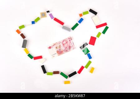 Lego bricks Great Wall of China concept outline of China world map with chinese yuan in center Stock Photo