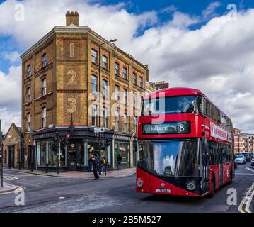 Bethnal Green Road East London. A Number 8 bus drives past 123 Bethnal Green Rd in the Shoreditch area of fashionable East London near Brick Lane Stock Photo