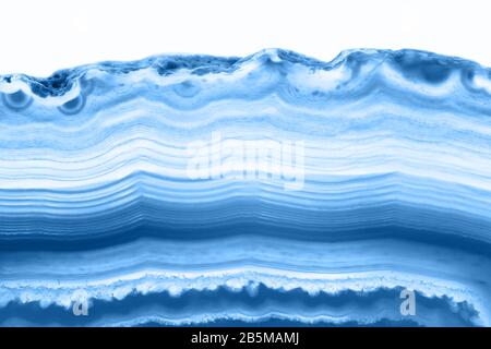 Abstract background agate cross section slice mineral isolated on white background, color of the year 2020 pantone classic blue 19-4052 Stock Photo