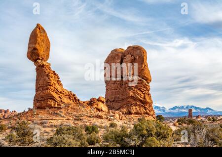 Balanced Rock towering over the desert landscape in Arches National Park in Moab, Utah USA. Stock Photo