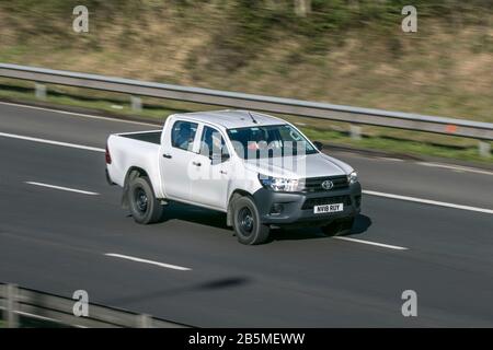 NV18RUY Toyota Hilux Active D-4D 4Wd Dcb White LCV Diesel driving on the M6 motorway near Preston in Lancashire, Uk Stock Photo