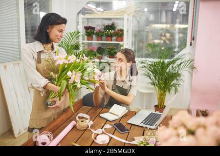 Portrait of two young businesswomen managing flower shop, copy space Stock Photo
