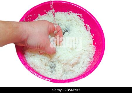 Wash rice with water in the plastic bowl Stock Photo
