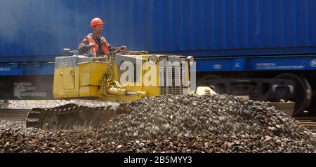 male operator driving excavator on construction building site Stock Photo