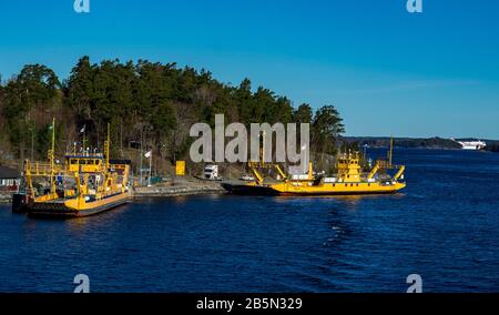 Yellow ferrya for transporting cars and people from the islands of the Stockholm archipelago to the mainland Stock Photo