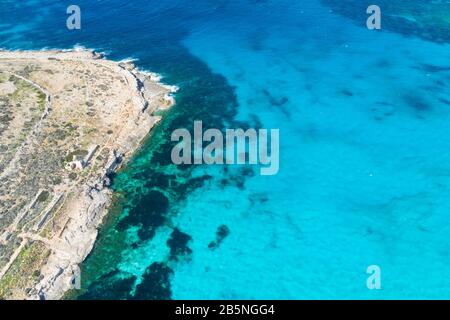Aerial drone photo - The famous Blue Lagoon in the Mediterranean Sea. Comino Island, Malta. Stock Photo