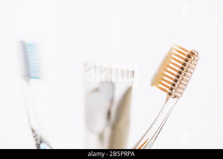 Two plastic toothbrushes and toothpaste on white background. Stock Photo