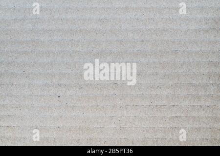 Gray background from sheet of recycled cardboard. Close-up detail macro photography view of abstract texture recycled carton material pattern Stock Photo