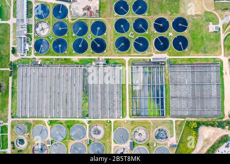 aerial top down view on sewage treatment facilities. water purification tanks and aeration basins at modern wastewater plant Stock Photo