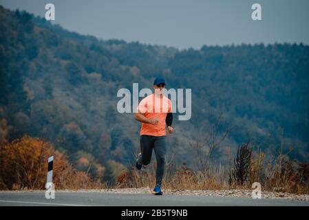 Well built middle aged athlete during a running exercise Stock Photo