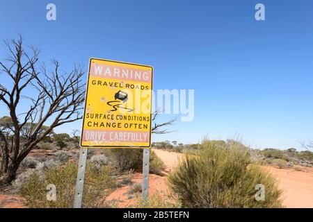 Warning Gravel Road sign, Australian Outback, South Australia, SA, Australia Stock Photo