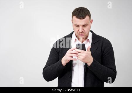 Portrait of businessman using smartphone over gray background Stock Photo