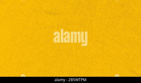 Vibrant yellow texture of binding fabric. Yellow textile background with natural folds. Close-up Stock Photo