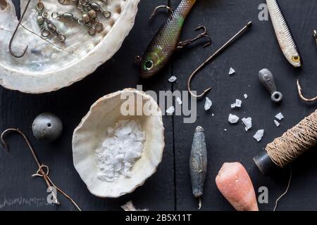 Variety of fishing hooks, lures, sinkers and shells, conceptual  stlll life overhead photo Stock Photo