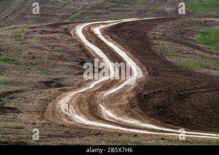 Winding dirt road in field Stock Photo