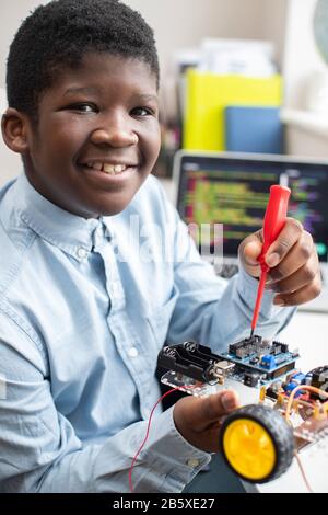 Portrait Of Male High School Pupil Building Robot Car In Science Lesson Stock Photo