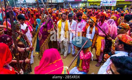 People celebrating lathmar holi in nand gaon Stock Photo