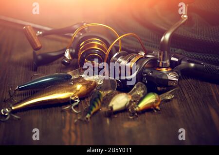 Fishing tackle - fishing spinning, hooks and lures on wooden background  with copy space Stock Photo - Alamy