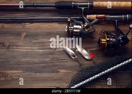 Fishing tackle - fishing spinning, hooks and lures on wooden background  with copy space Stock Photo - Alamy
