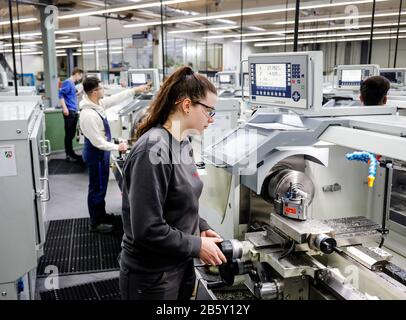 Remscheid, North Rhine-Westphalia, Germany - Trainee woman in metal professions working at the lathe, vocational training centre of the Remscheid meta Stock Photo