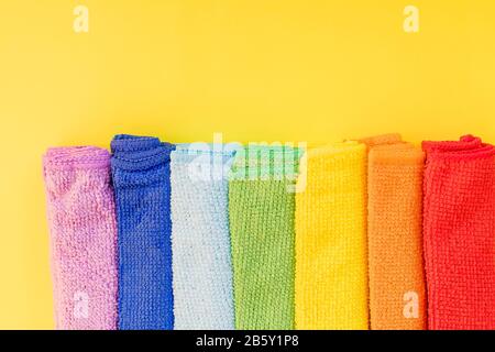 colorful microfiber towels, over yellow background.Cleaning microfiber cloth isolated , Folded cleaning textile napkins colorful stack. Domestic Stock Photo