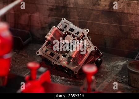 Horizontal shot of modern car motor part lying on auto service garage floor, copy space Stock Photo