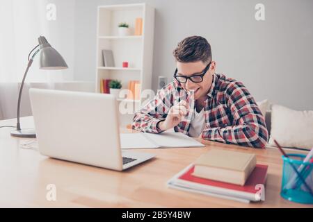 Young smart student in glasses preparing for difficult exam Stock Photo