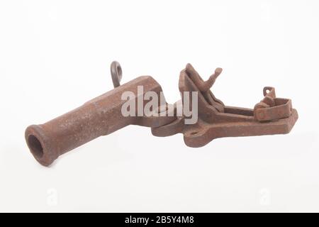 An old, metal alarm gun used for deterring poachers. The gun could be loaded with a shotgun cartridge and was fired by a trip wire. The loud bang woul Stock Photo