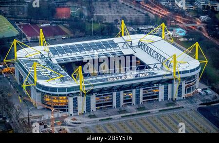 Dortmund, Deutschland. 17th Dec, 2013. firo: football, soccer, 17.12.2013 1.Bundesliga, season 2012/2013 BVB, Borussia Dortmund, aerial view aerial view in the aftert overview stadium aftert shot afterlighting with floodlights lamps artificial lighting of the pitch in the signal Iduna PArk aerial photo, Westfalenstadion Dortmund, luminous pitch heating, yellow black, Signal IdunaPark, Signal Iduna Park, BVB Stadion, Dortmund Stadtkrone, Westfalenhalle Dortmund area and Dortmund Stadium, Dortmund, Ruhr area, North Rhine-Westphalia, Germany, Europe | usage worldwide Credit: dpa/Alamy Live News Stock Photo