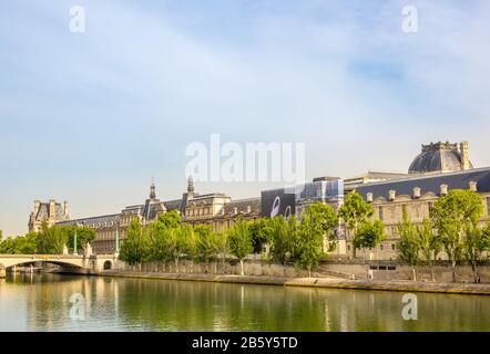 France. Summer sunny day in Paris. Seine River Embankment and the Louvre Museum Façade Stock Photo