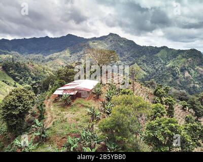 Rural farm in mountain landscape aerial drone view Stock Photo