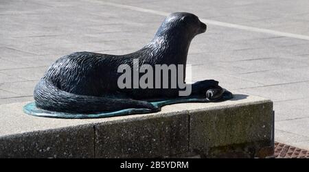 Bronze Statue of Tarka the Otter Lying down in Bideford (Kingsley's Little White Town) on the Tarka Trail/South West Coast Path, North Devon. England. Stock Photo