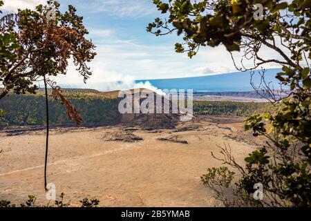 Smoke rising from a sleeping dormant volcano in Hawaii Volcanoes National Park. Stock Photo